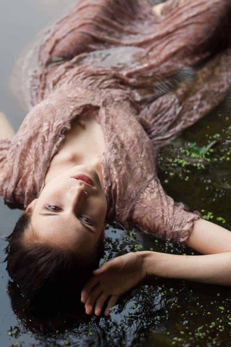 Melanie portrays Ophelia in the pond on Staten Island in a dusty rose lace dress