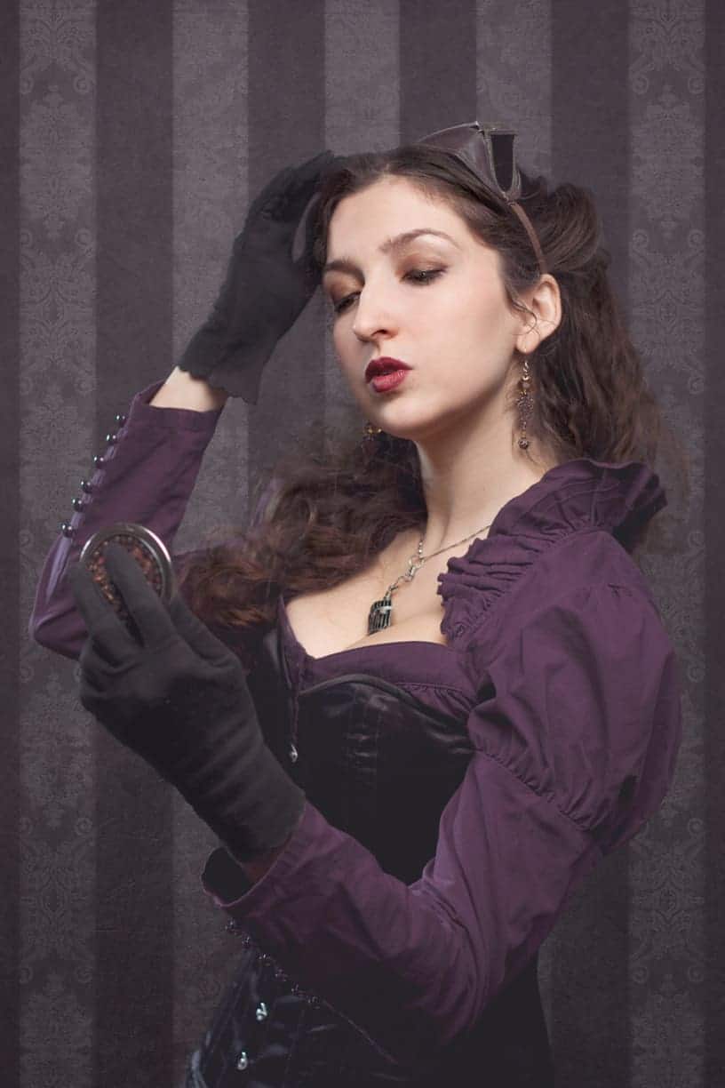 Victorian portrait of Tiffay in purple holding a mirror